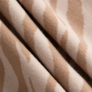 Zebra stripe wool scarf in khaki with soft fringe detail.