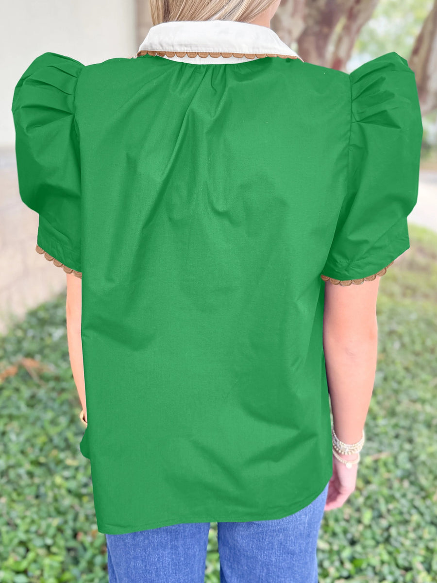 Green cotton blouse with ricrac trim, puff sleeves, and white collar.