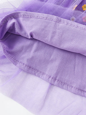 Purple toddler tulle dress with cotton lining and floral appliqué detail.
