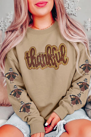 gold sweatshirt featuring sequin embellishment and graphic