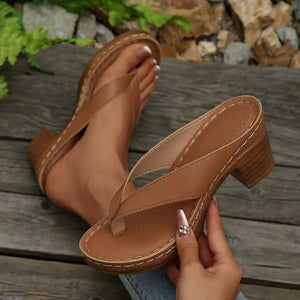 Tan leather toe-post block heel sandals with white stitching detail.