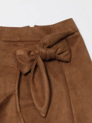 Brown midi skirt with a tie waist and slit detail.