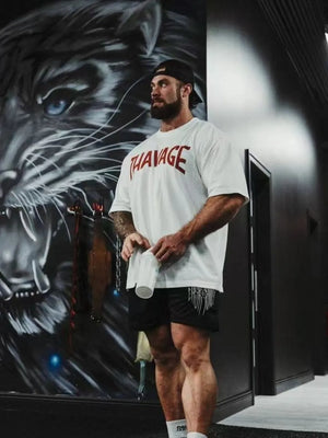 White oversized graphic tee with red THAVAGE print and short sleeves.