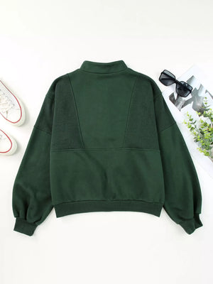 Dark green half zip stand collar sweatshirt with paneled detail