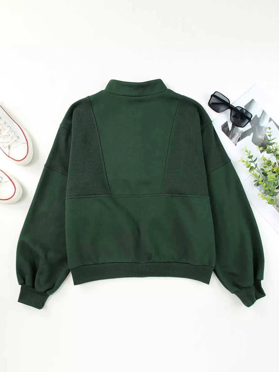 Dark green half zip stand collar sweatshirt with paneled detail