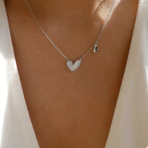 Silver heart pendant necklace with a smaller heart charm on a delicate chain