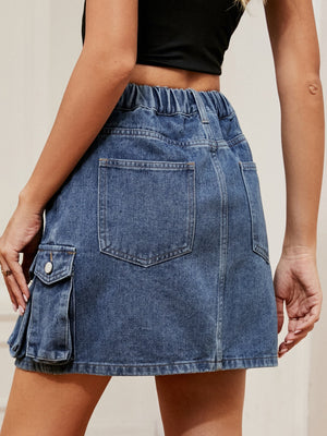 Denim cargo skirt in dark blue with elastic waist and utility pockets.
