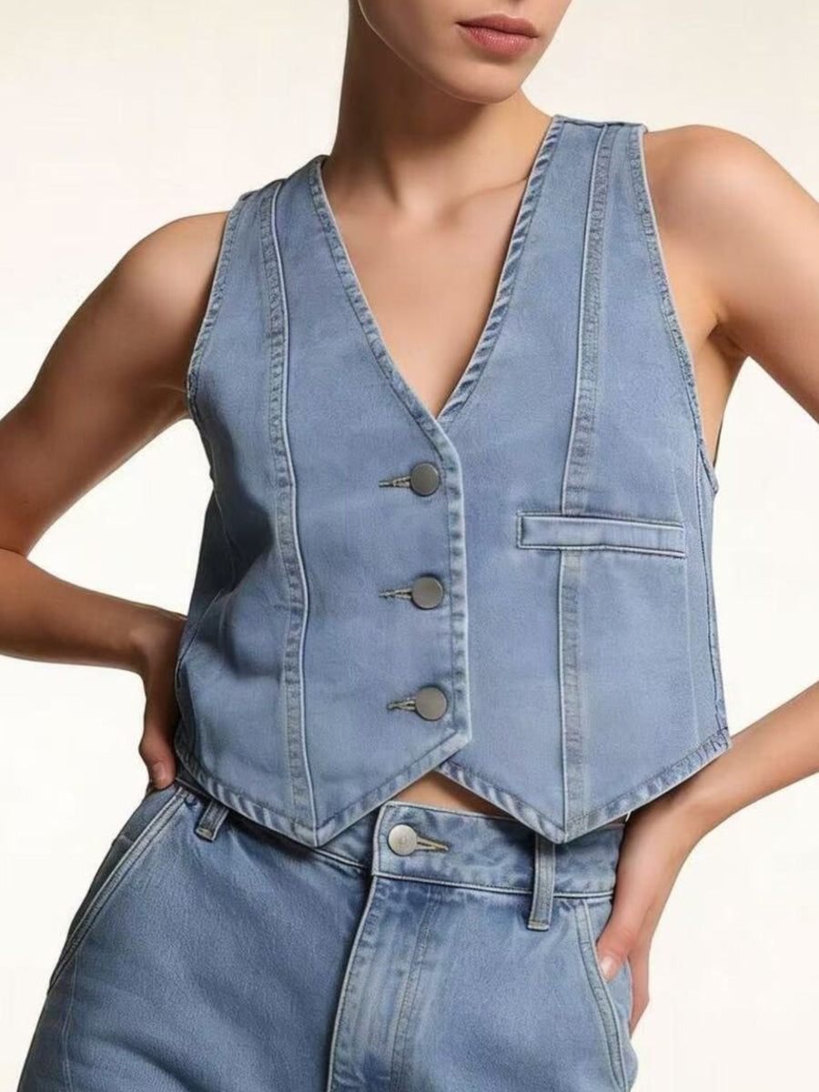 Light blue denim vest with button front and single chest pocket.