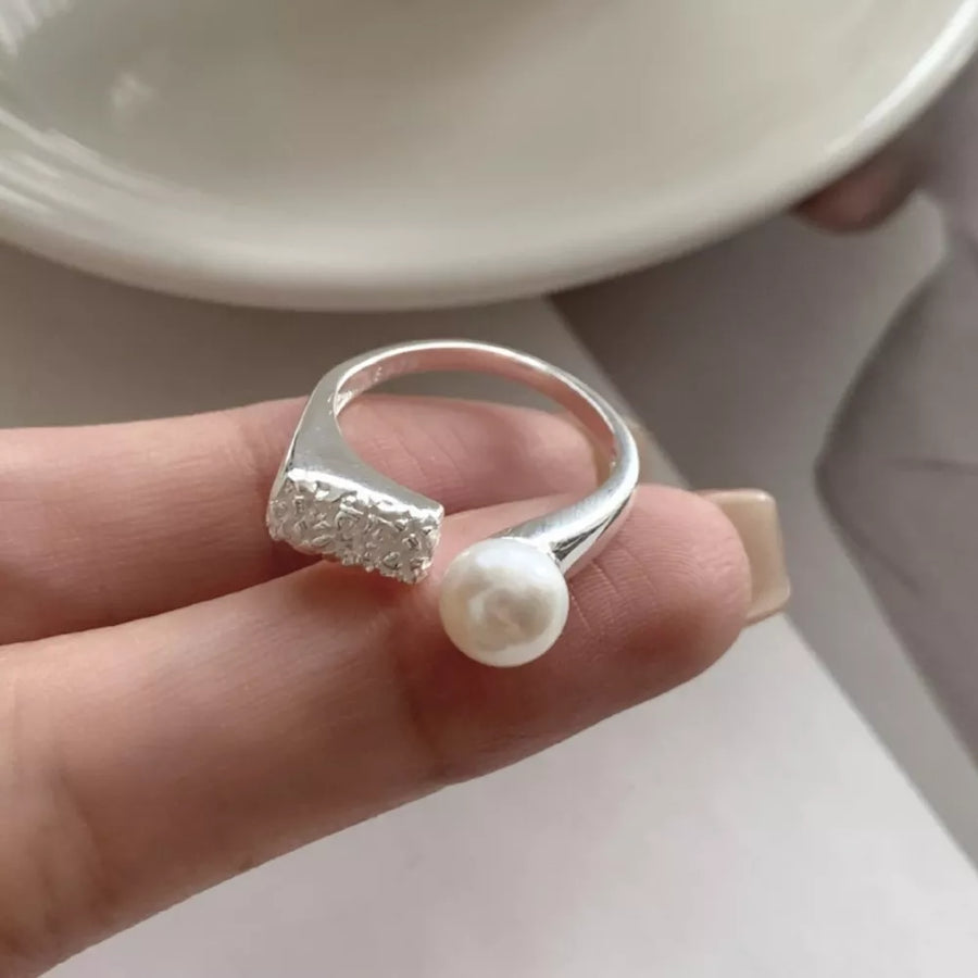 white ring featuring open design and textured