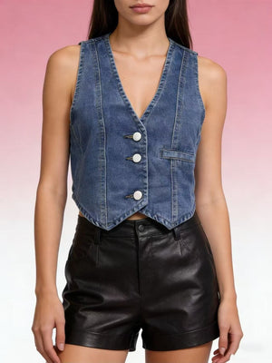Chic button-down denim vest in dark blue with white buttons and a single chest pocket.