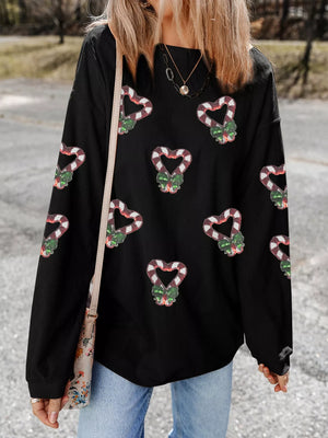 Black drop shoulder sweatshirt with allover sequin candy cane heart pattern.