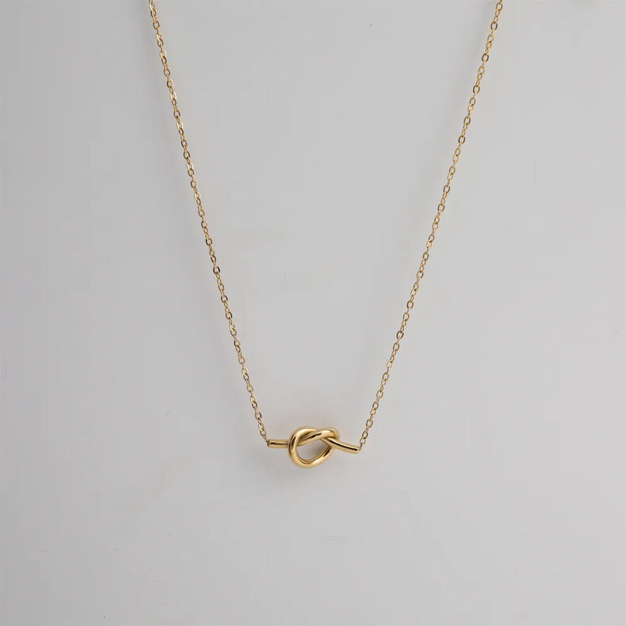 Gold knot pendant necklace with delicate chain, 18K gold-plated.
