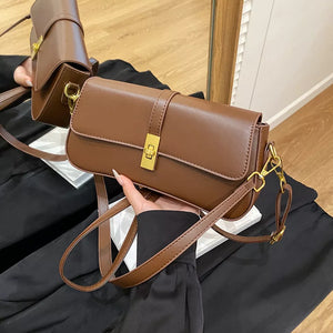 Brown rectangular crossbody bag with gold clasp and adjustable strap