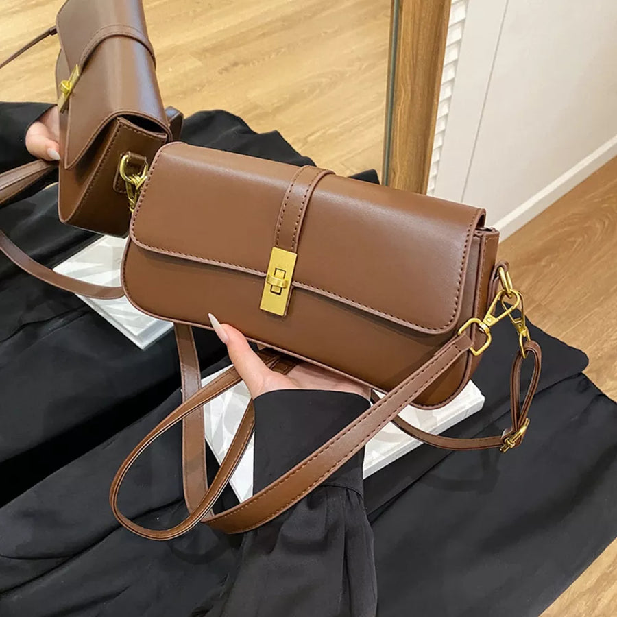 Brown rectangular crossbody bag with gold clasp and adjustable strap