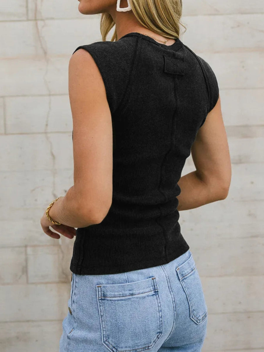Black ribbed tank top with seamed shoulders and a cropped length.