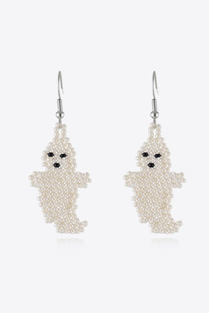 Ivory beaded ghost fringe earrings with black bead eyes and mouth.