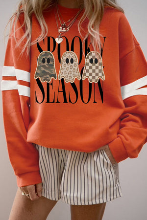 white sweatshirt featuring graphic print and striped