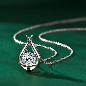 Silver teardrop pendant necklace with a round moissanite stone