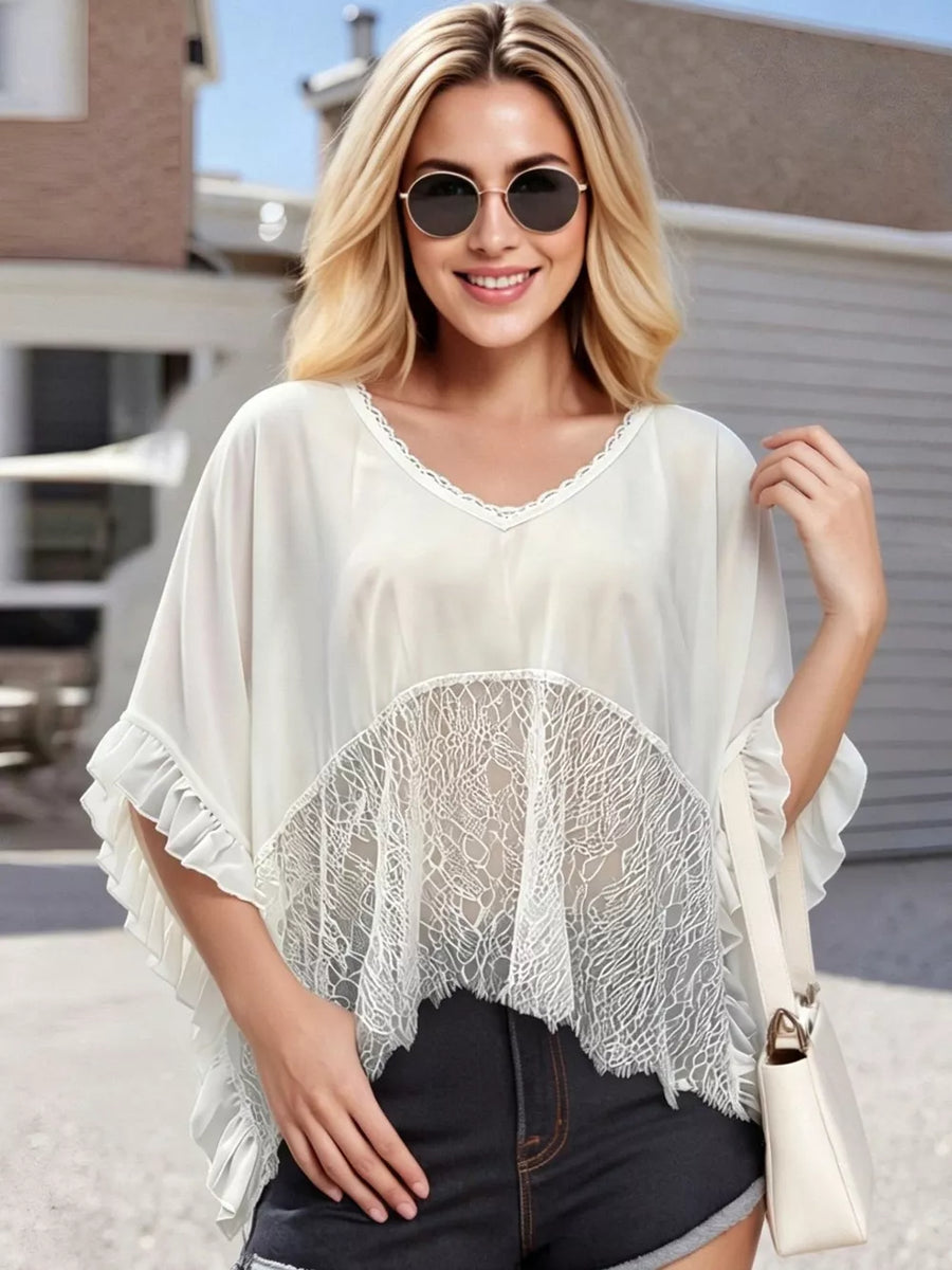 White lace-trimmed sheer flowing cover-up with ruffled sleeves and V-neck.