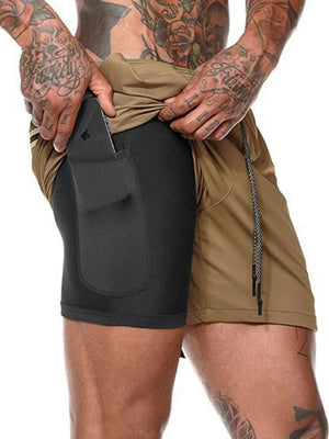 Dual-layer performance shorts in camel with black compression liner and phone pocket.