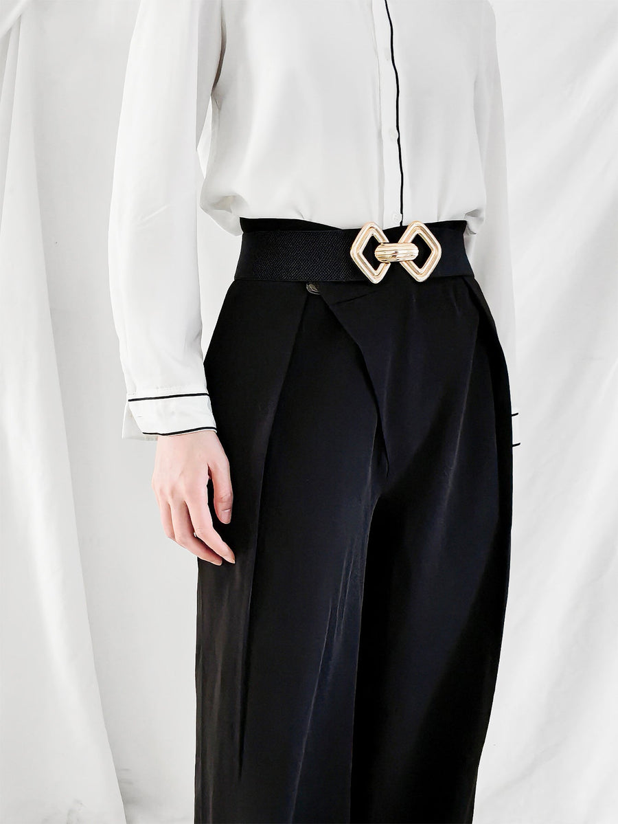 Black elasticated waist belt with gold geometric buckle detail