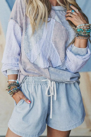 Light blue pinstripe drawstring shorts with a relaxed fit and pockets.