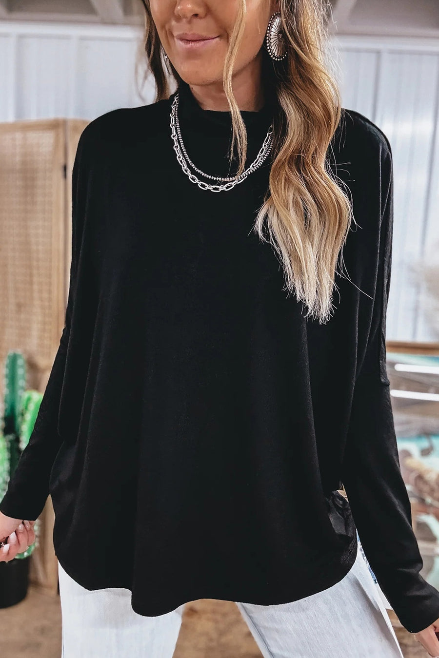 top in black featuring stretch and relaxed fit