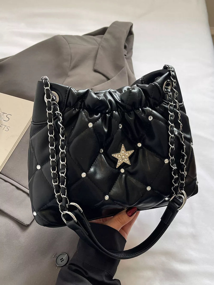 Black quilted shoulder bag with rhinestone star and diamond pattern details.