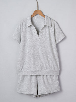 Grey polo collar loungewear set with short sleeves and shorts made of polyester.