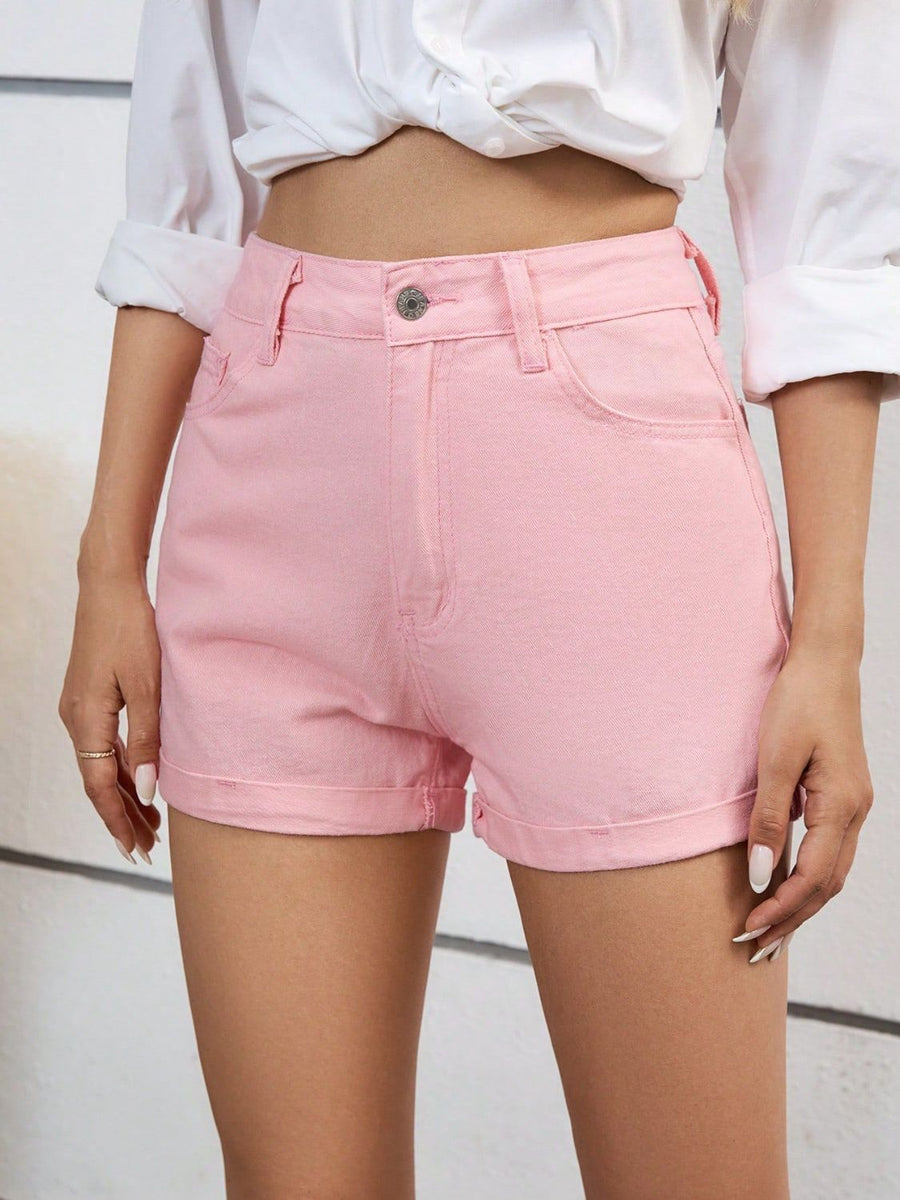 Blush pink denim high-waist shorts with cuffed hems.