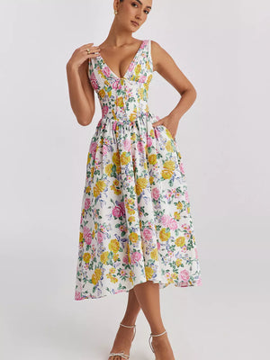 Floral print midi dress with V-neck and pockets in cream with pink and yellow flowers.