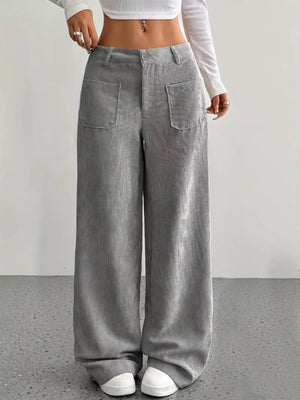 Grey corduroy wide-leg trousers with front pockets and a comfortable fit.