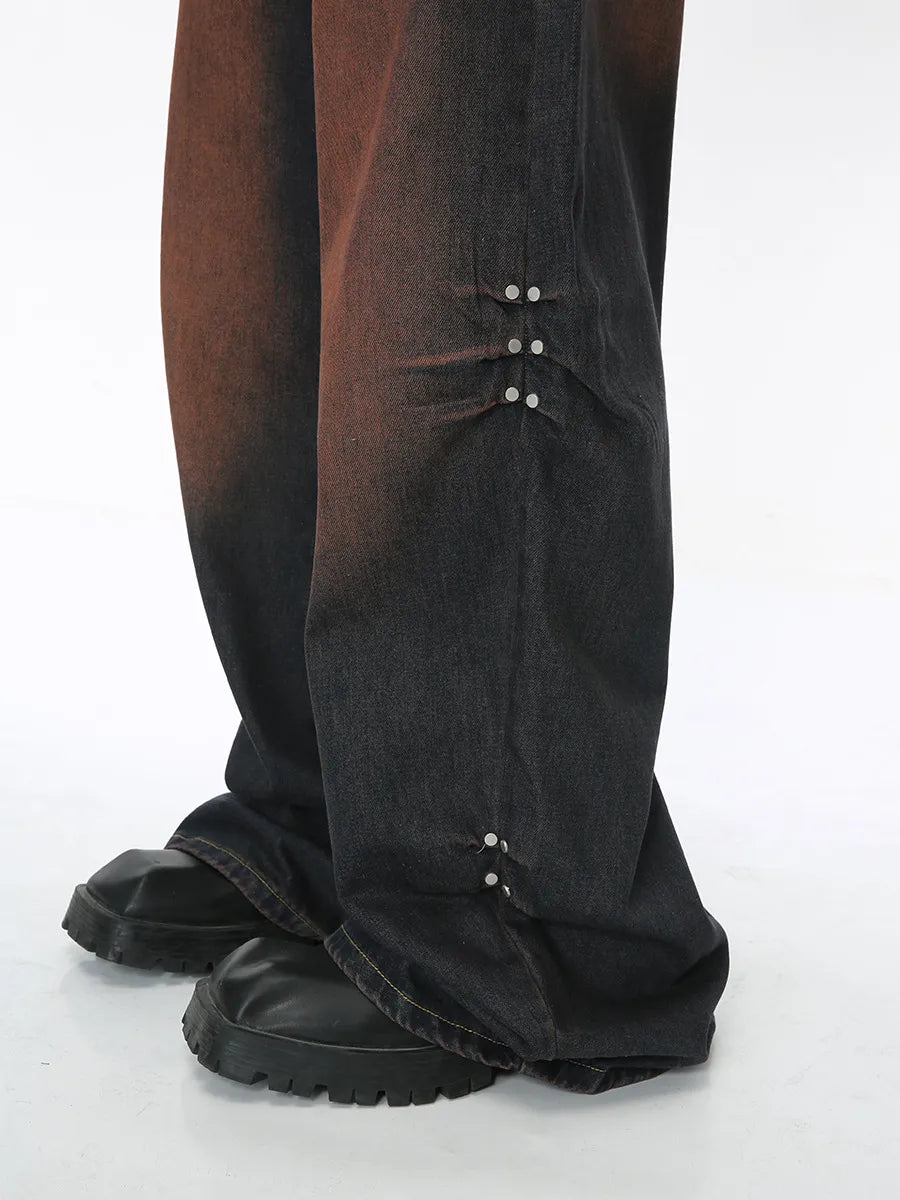 Acid wash flare jeans in dark denim with silver stud details on the leg.