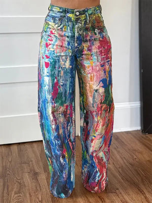 Abstract print high-waisted wide-leg cotton blend jeans with a colorful, painterly design.
