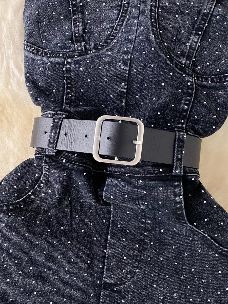 Black denim romper with allover rhinestones and a black belt.