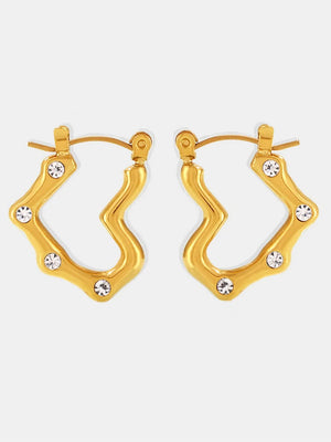Gold wave hoop earrings with clear crystal accents