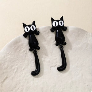 white earrings featuring dangle and novelty