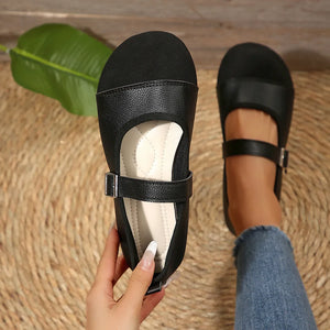 Black Mary Jane flats with buckle strap and cap toe detail