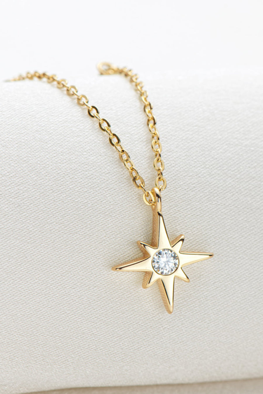 Gold celestial compass pendant necklace with moissanite on a delicate chain.