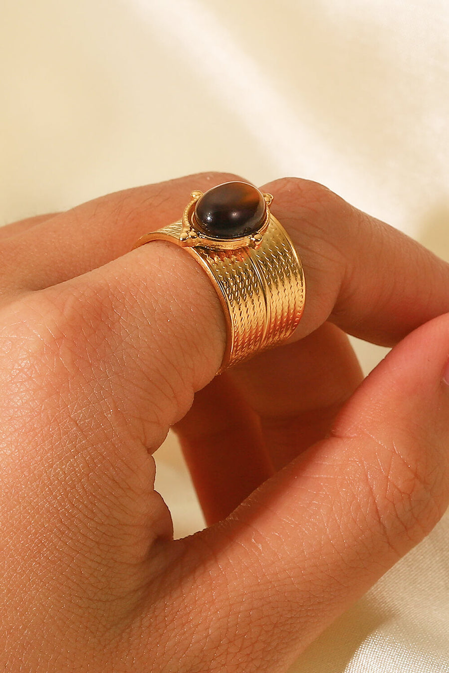 Textured tiger's eye cuff ring in brown with gold-tone band.