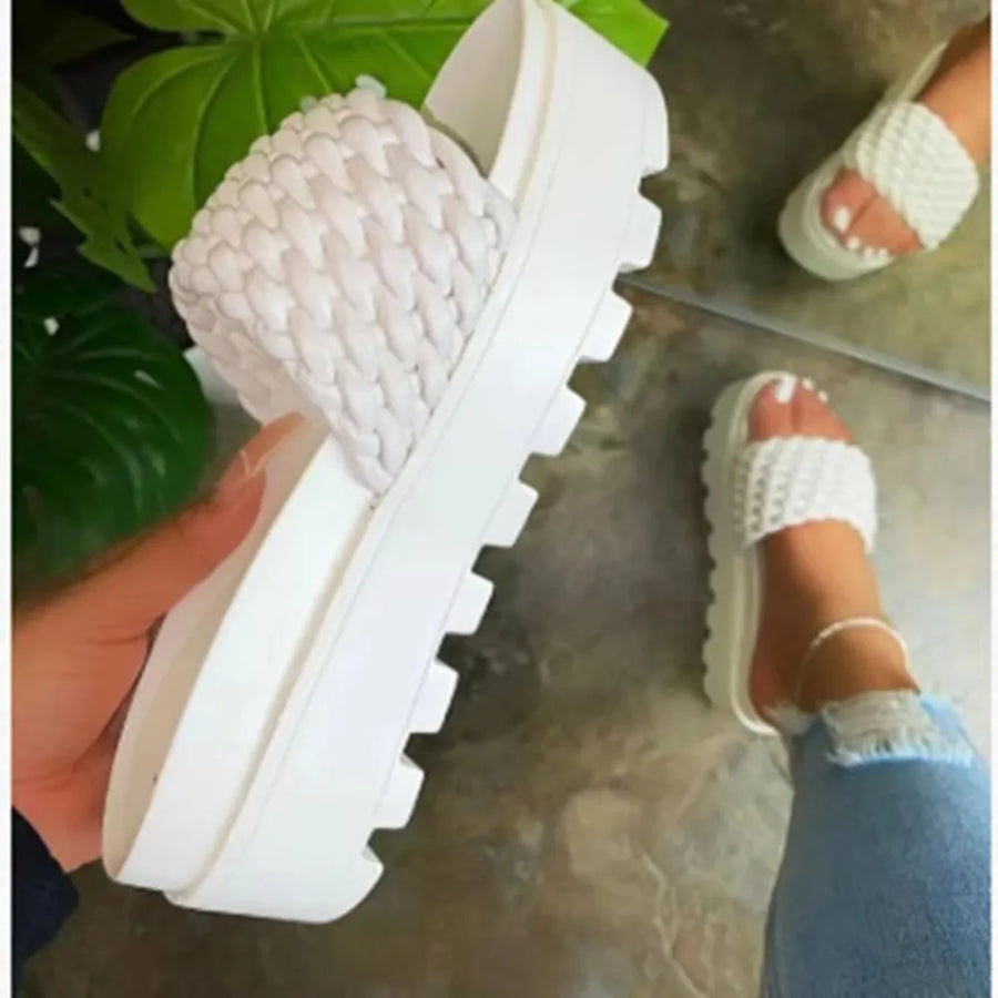 White woven platform slide sandals with a chunky lug sole.