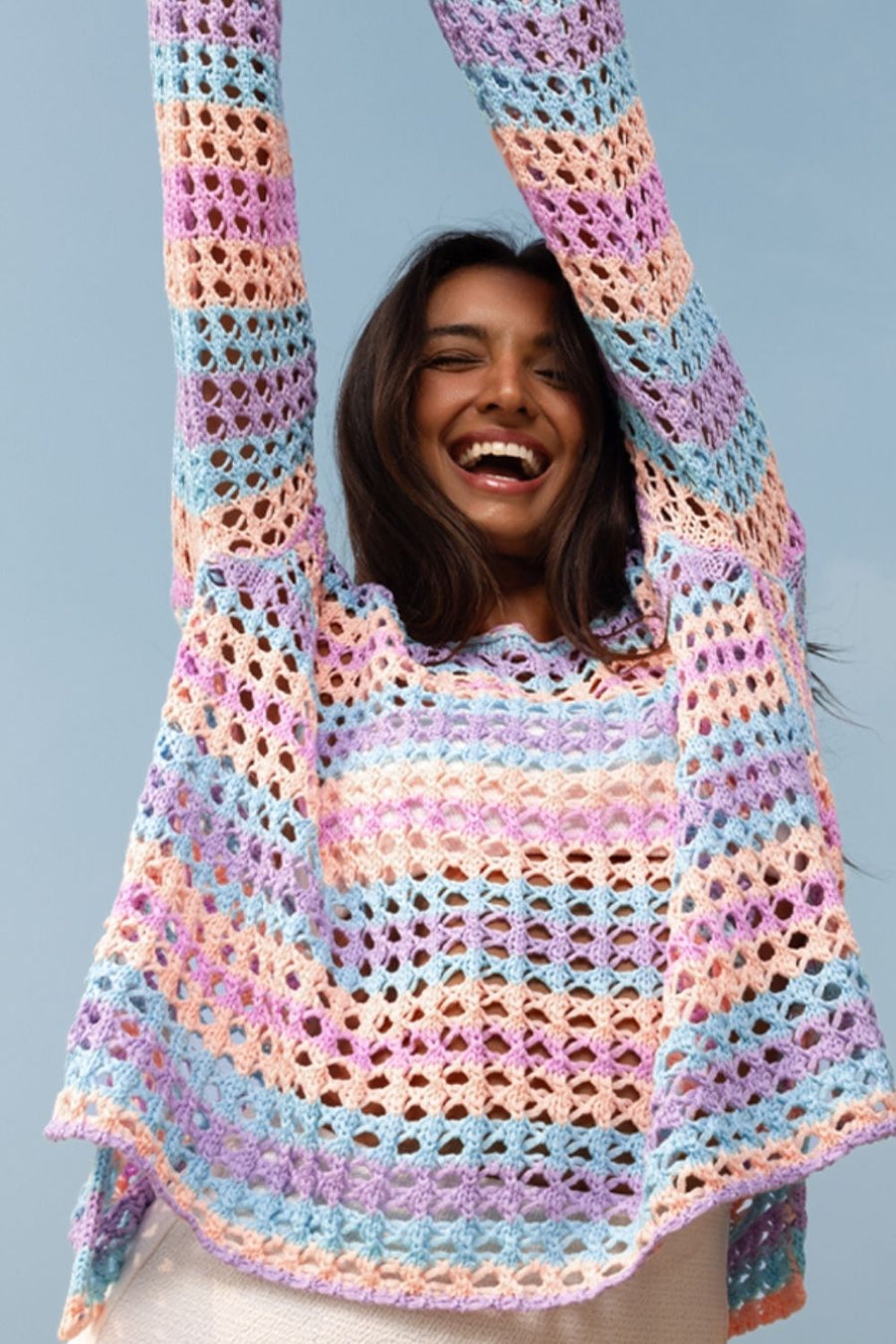 Pastel crochet beach cover-up with striped pattern and open knit detail.