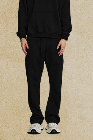 Black relaxed fit joggers with drawstring waist and pockets.