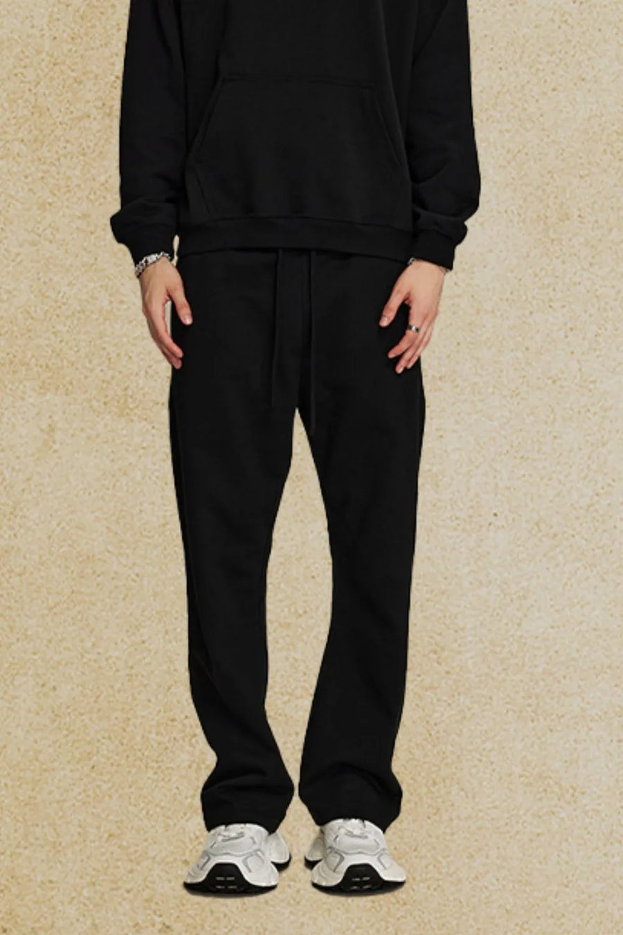 Black relaxed fit joggers with drawstring waist and pockets.
