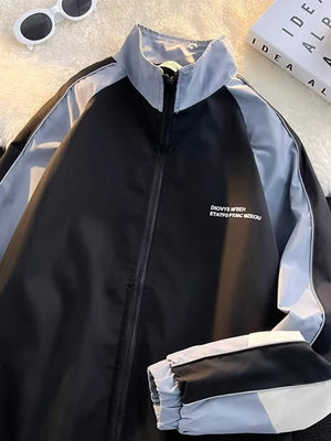 Men's black track jacket with light grey accents and white text detail.