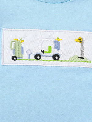 Light blue cotton tee with embroidered golf cart, golf bag, and giraffe flag detail.