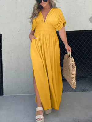 Yellow V-neck dolman sleeve maxi dress with smocked waist and side slits.