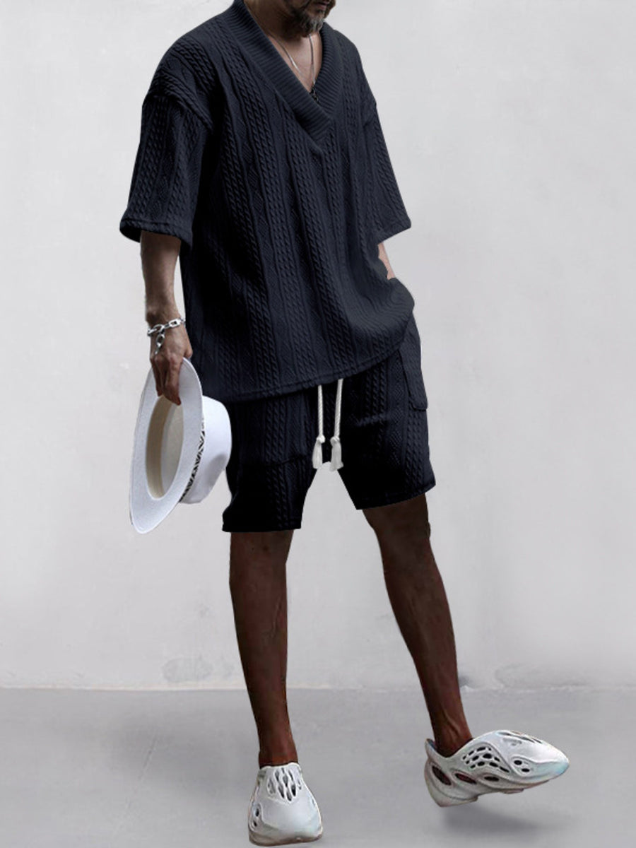 Black cable-knit V-neck two-piece set with shorts and short sleeves.