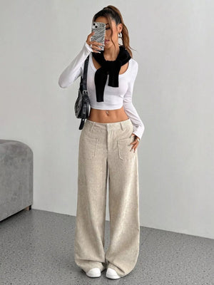Chic wide-leg corduroy trousers in apricot with large front pockets and a relaxed fit.
