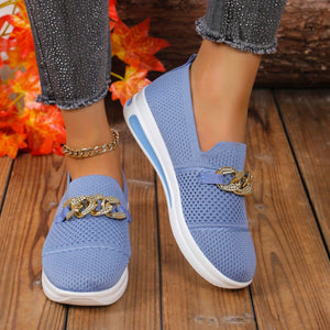 Sky blue mesh slip-on flats with chunky gold chain detail and white soles.